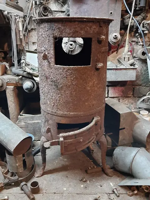 Rusted cast iron stove in the basement